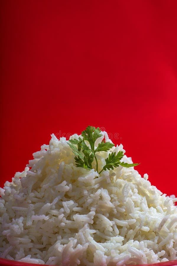 Cooked Plain White Basmati Rice in a Red Plate on Red Background Stock
