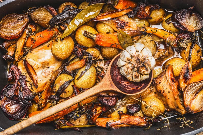 Cooked rabbit stew with forest mushrooms , roasted vegetables of season and rustic wooden spoon royalty free stock photos Cooked rabbit stew with forest mushrooms , roasted vegetables of season and rustic wooden spoon royalty free stock photos