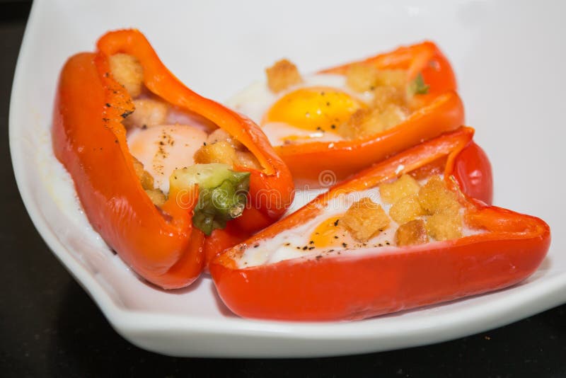 Cooked Stuffed Red Peppers with Eggs, Ham and Croutons. Stock Photo Image of plate, crufts