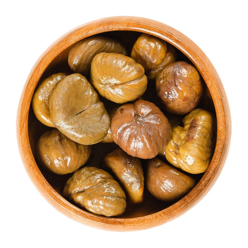 Cooked sweet chestnuts in wooden bowl over white