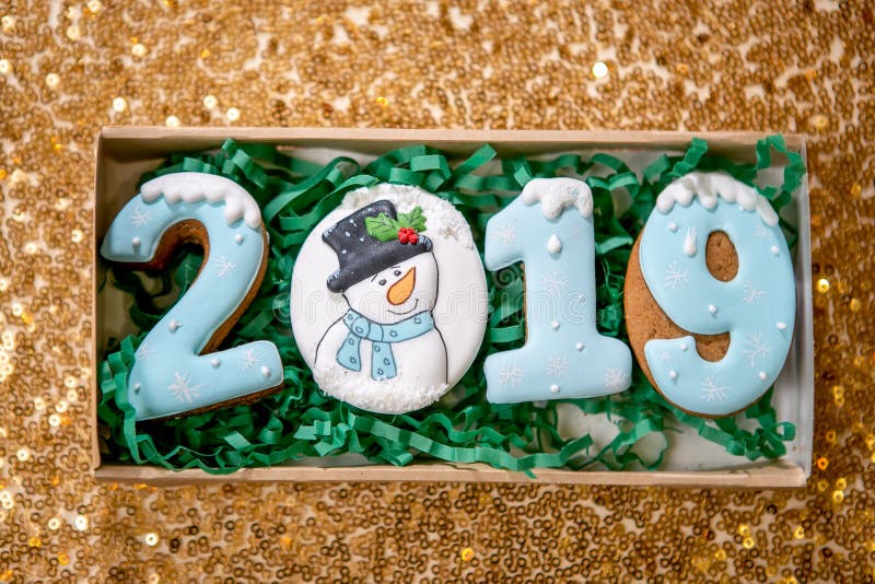 Cookie sob a forma do números 2019 na caixa da caixa no fundo dourado Doces do feriado O tema de ano novo e de Natal festive fotos de stock Cookie sob a forma do números 2019 na caixa da caixa no fundo dourado Doces do feriado O tema de ano novo e de Natal festive fotos de stock
