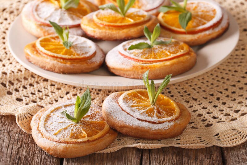 Cookies with almonds and oranges closeup on a plate. horizontal