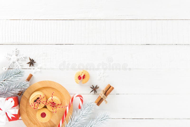 Cookies, candy cane and Christmas decorating items on white wood board background, border design with copy space. Cookies, candy cane and Christmas decorating items on white wood board background, border design with copy space