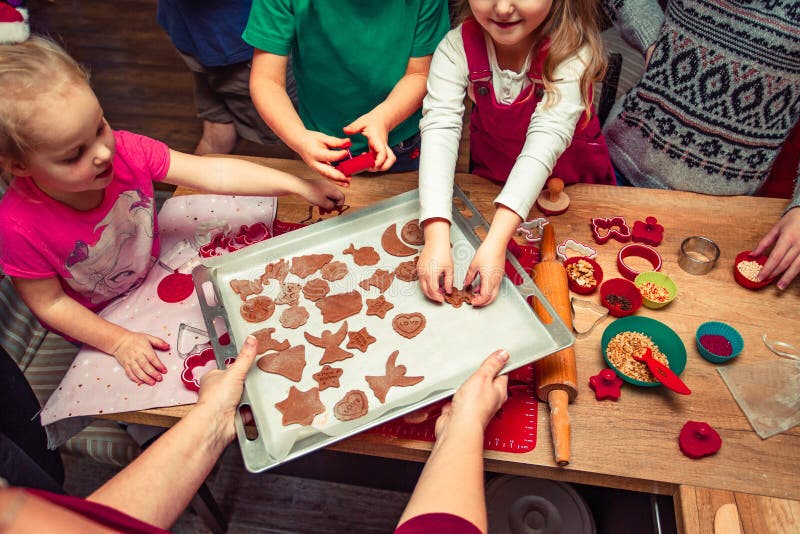 Baking Christmas cookies. Christmas gingerbread cookies in many shapes decorated with colorful frosting, sprinkle, icing, chocolate coating, toppers, put on table. Baking traditional cookies. Family celebrating Christmas. Baking at home. Baked sweet cookies. Coating with frostings. Colouring cookies. Decorating baked cookies. Decoration and design of food. Flat top-down composition. Sweet dessert. Baking Christmas cookies. Christmas gingerbread cookies in many shapes decorated with colorful frosting, sprinkle, icing, chocolate coating, toppers, put on table. Baking traditional cookies. Family celebrating Christmas. Baking at home. Baked sweet cookies. Coating with frostings. Colouring cookies. Decorating baked cookies. Decoration and design of food. Flat top-down composition. Sweet dessert