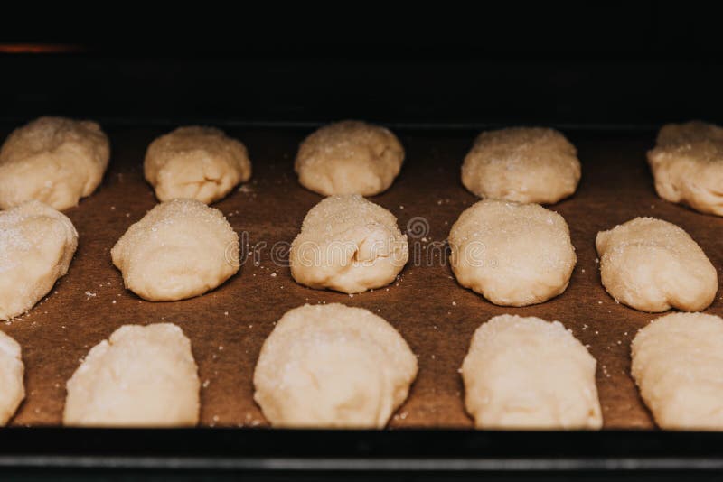 Shaped cookies with sugar sprinkles on a baking sheet. Shaped cookies with sugar sprinkles on a baking sheet.