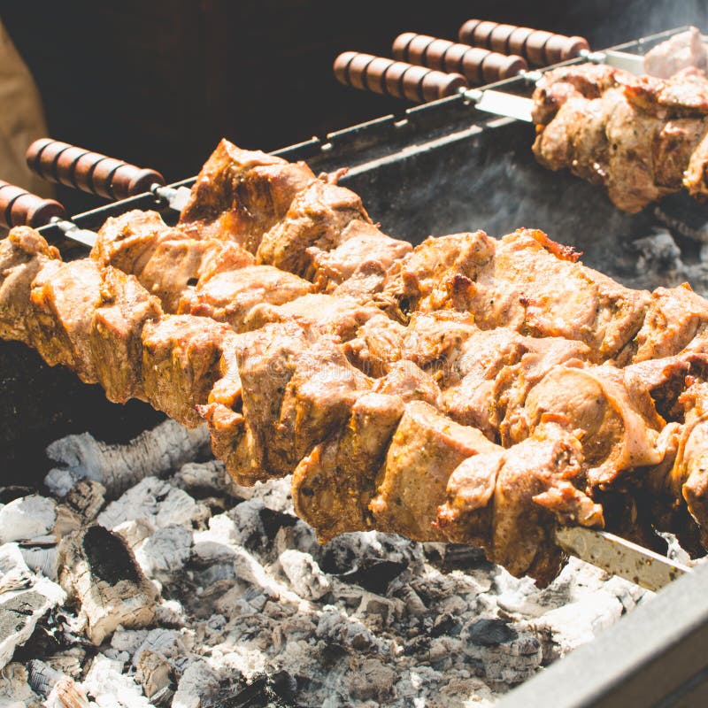 Cooking Barbecue. Pork Meat Roasted on a Spit. Selective Focus. Square