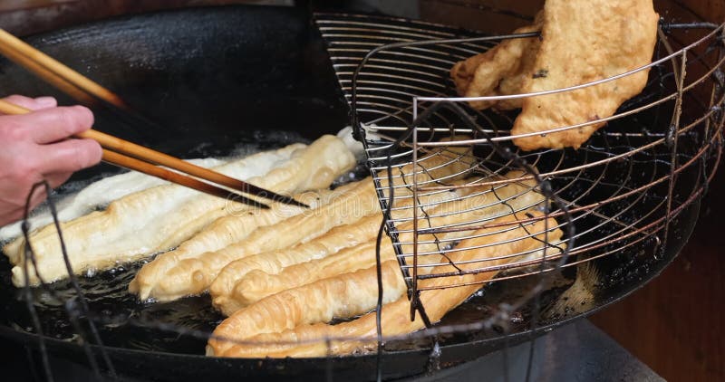 Cooking Chinese deep-fried dough stick also called youtiao