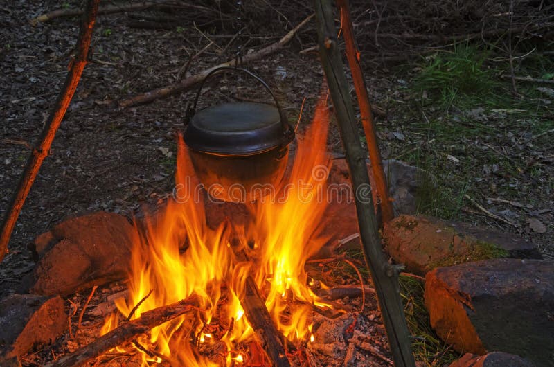 Cooking dinner in cauldron pot over an open fire stock image Cooking dinner in cauldron pot over an open fire stock image