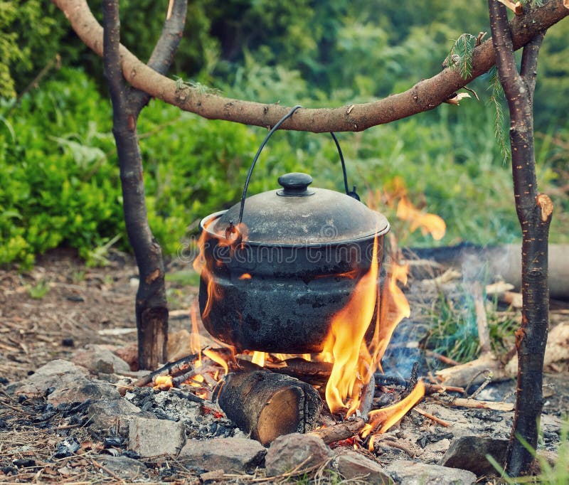 Cooking in Field Conditions, Boiling Pot at the Campfire Stock Image