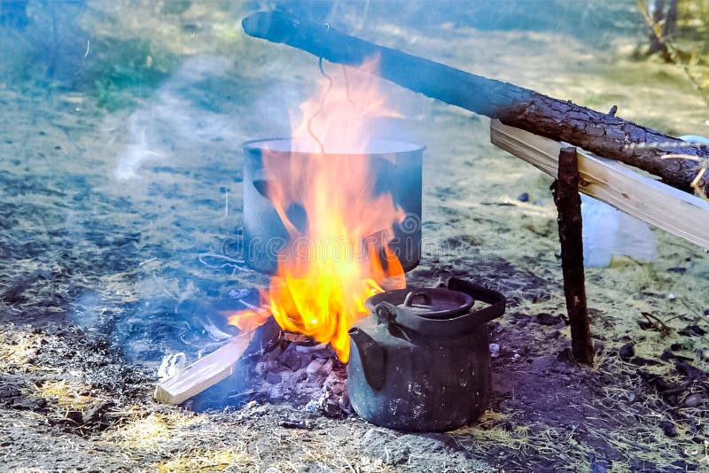 Cooking on a fire in a pot stock image. Image of bowler 140473891