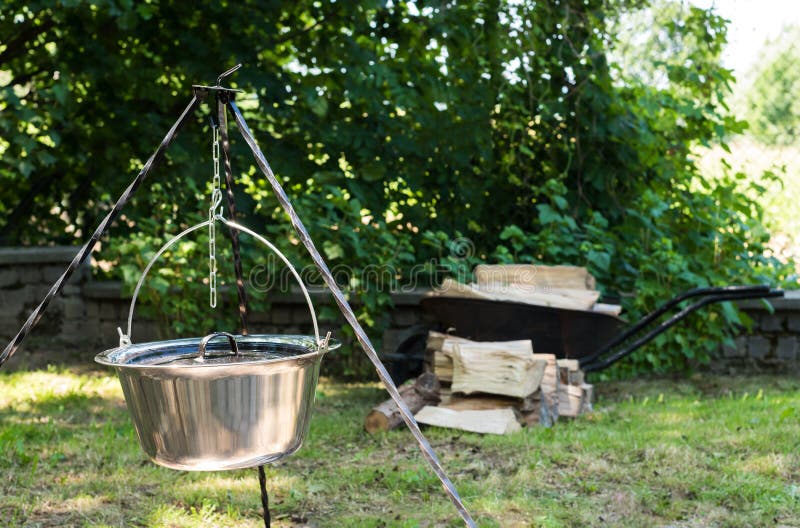 Cooking Food on Fire. Cooking Outdoors in Castiron Cauldron. Stock