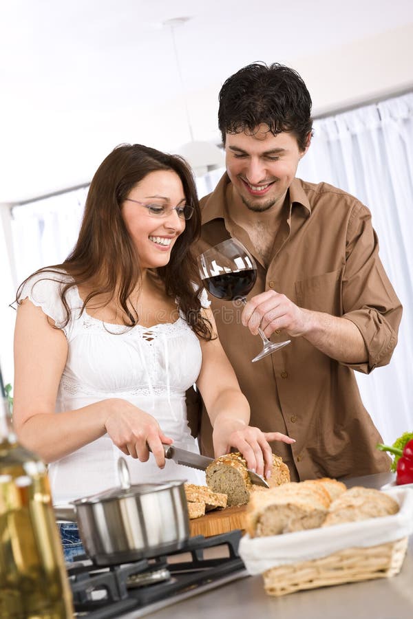 Cooking - happy couple together in modern kitchen