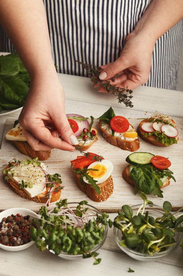 Feamale hands making healthy bruschettas for right snack