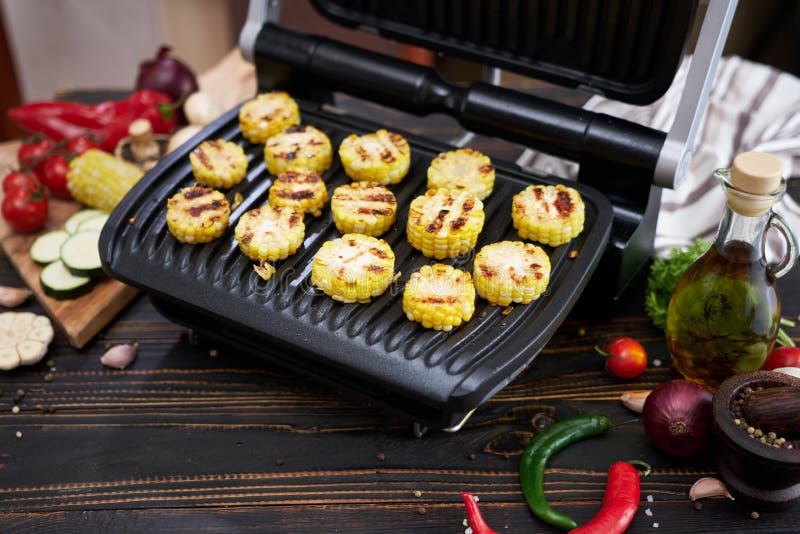 Cooking at Home on Electric Grill Sliced Corn Cobs Stock Image
