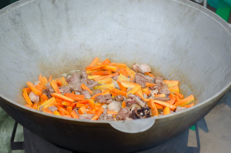 Cooking Meat Outdoors in Castiron Cauldron. Stock Photo Image of