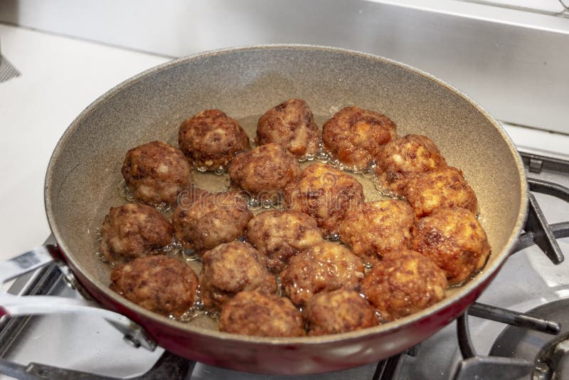 Cooking meatballs in oil stock image. Image of fried 180445623