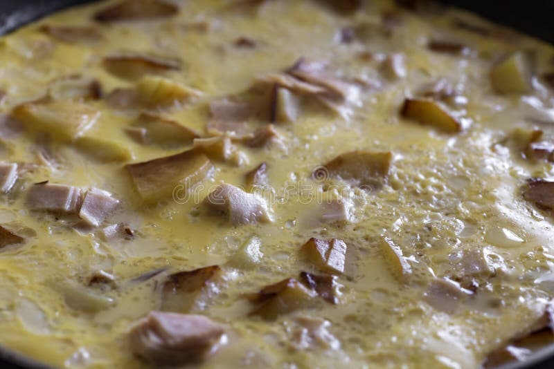 Cooking omelette made with eggs, potatoes and ham stock photos Cooking omelette made with eggs, potatoes and ham stock photos