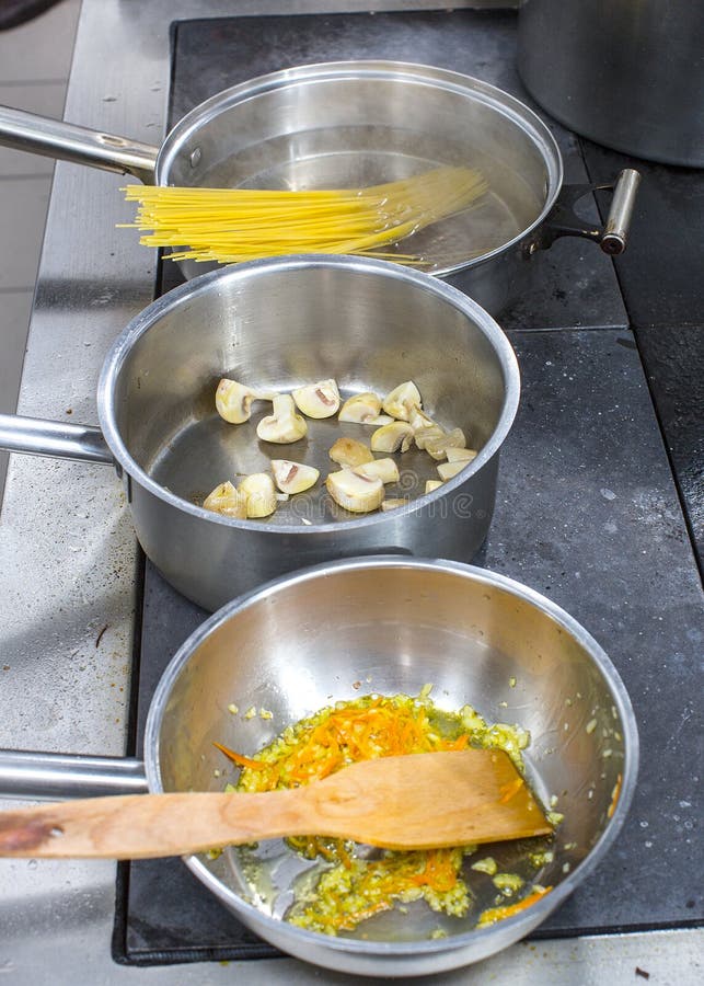 Pots And Pans On Stove In Restaurant Kitchen, The Chef Working I Stock