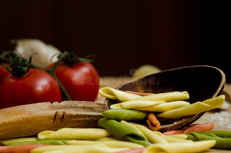 Cooking Pasta with Focus on Spoon Full of Colored Pasta Stock Image