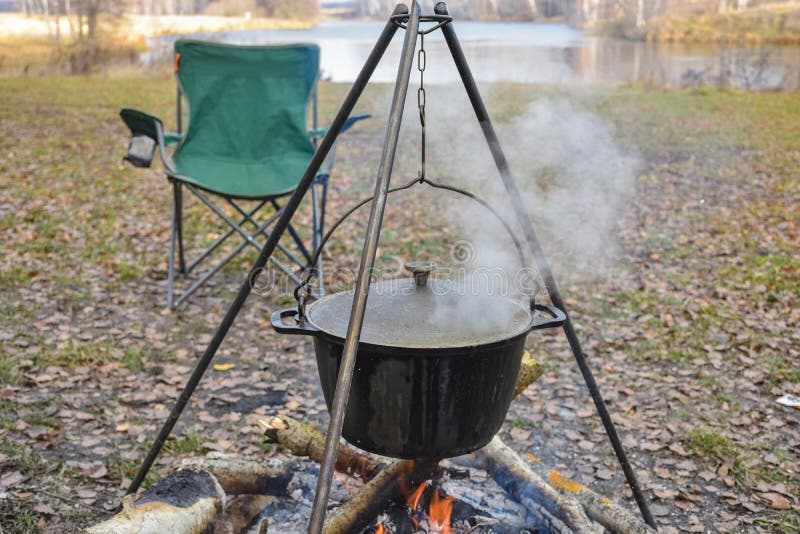 Cooking in Pot on Campfire, Camp Cooking, Pot with Hot Food Stock Image