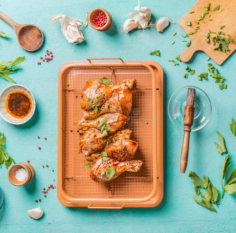 Cooking preparation of raw chicken drumsticks. Raw marinated Chicken legs on grill grid with ingredients, herbs, spices , sauce royalty free stock images Cooking preparation of raw chicken drumsticks. Raw marinated Chicken legs on grill grid with ingredients, herbs, spices , sauce royalty free stock images