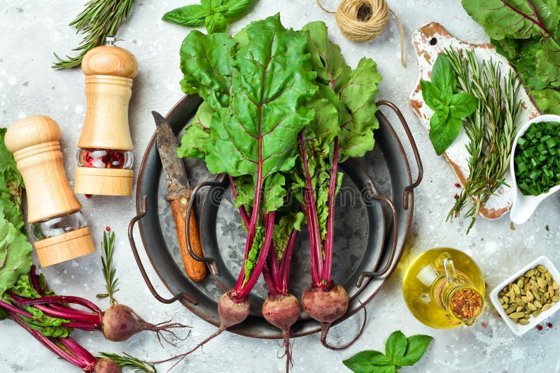 Cooking. Red Beets with Young Leaves on a Kitchen Background Stock