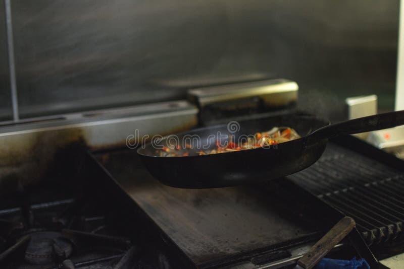Cooking in a Restaurant Onion and Red Pepper. Stock Photo Image of