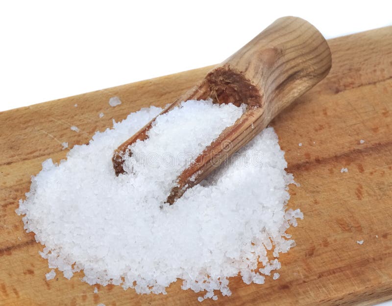 Cooking salt on wooden board with spoon