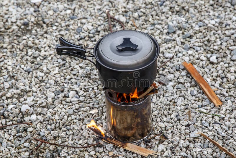 Cooking on a small camping stove in a mountain camp royalty free stock photos Cooking on a small camping stove in a mountain camp royalty free stock photos