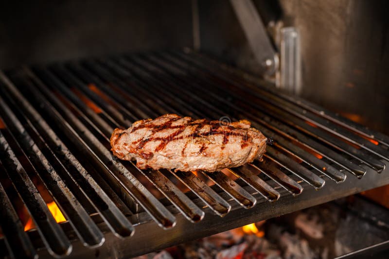 Cooking Steaks on a Grill with Fire. Shot with Selective Focus Stock