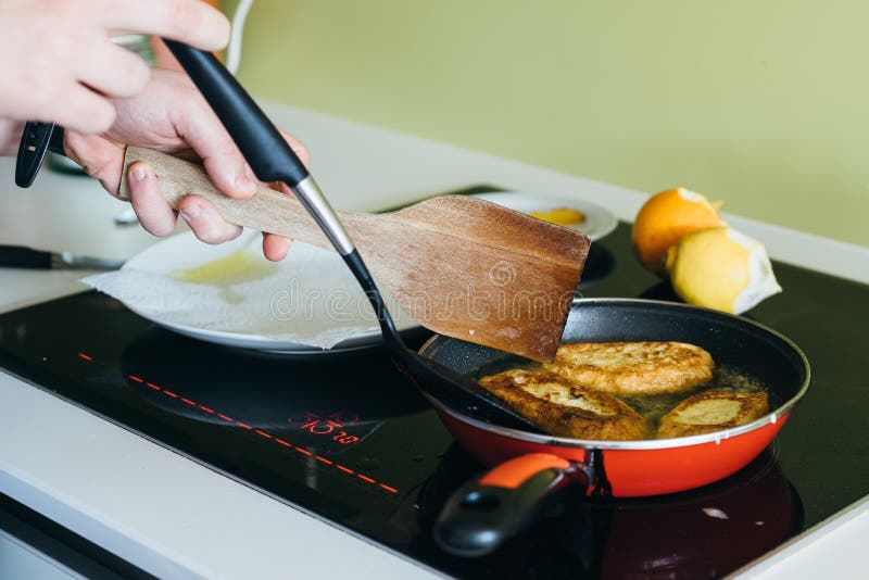 Cooking torrijas, a typical Spanish sweet fried toasts of sliced bread soaked in eggs and milk.