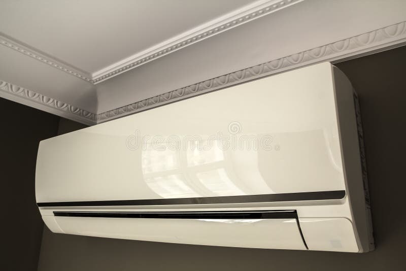 Cool Air Conditioner System on Dark Wall in Room Interior Stock Photo