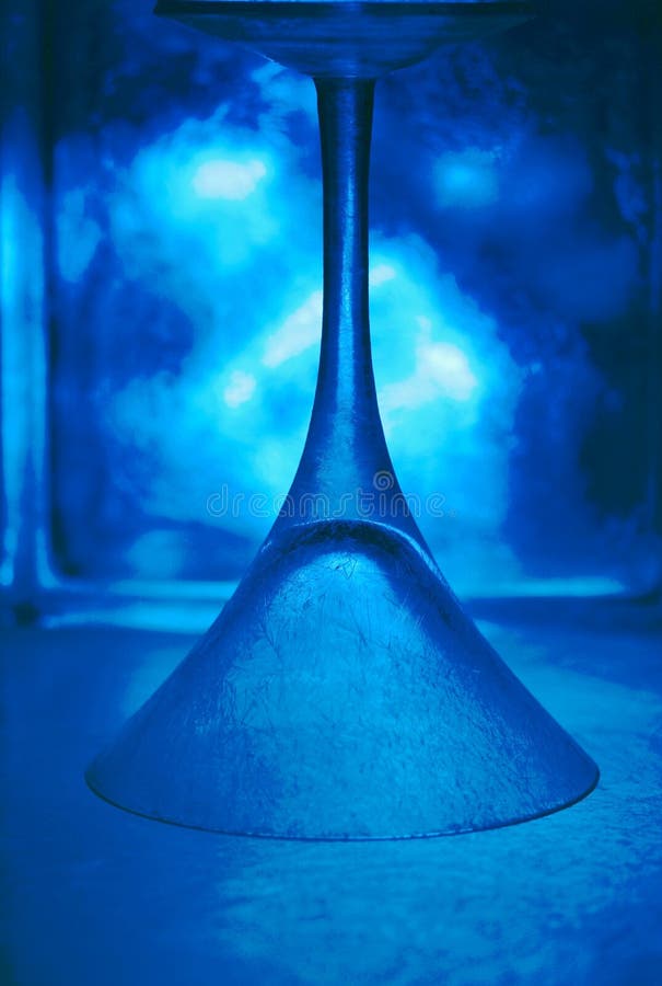 Cool blue upside down frosted martini glass royalty free stock photography