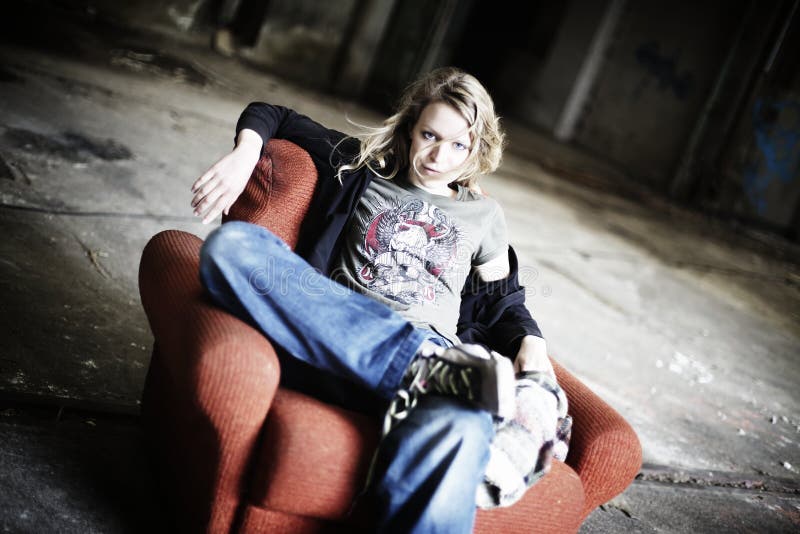 Cool girl sitting in old red sofa