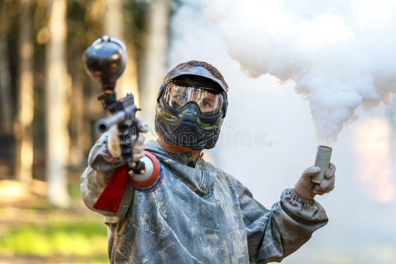 Cool Guy with Paintball Gun and Smoke Grenade Stock Photo Image of