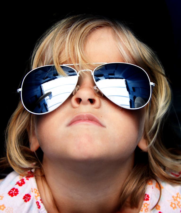 Close up of a young child wearing funky reflective sunglasses. Close up of a young child wearing funky reflective sunglasses