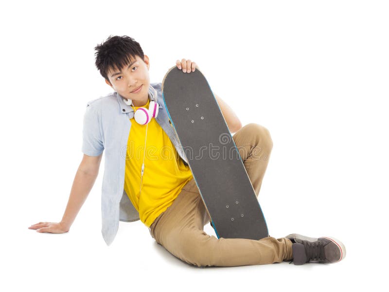 Cool man sitting and holding a skateboard