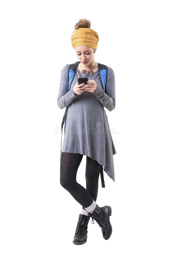 Cool modern stylish hipster traveler woman with rucksack reading messages on cellphone. royalty free stock images Cool modern stylish hipster traveler woman with rucksack reading messages on cellphone. royalty free stock images