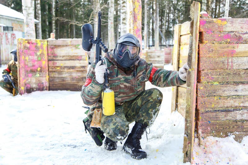 Cool Paintball in Winter. Two Shooters Behind Fortifications. Stock Photo Image of paintball