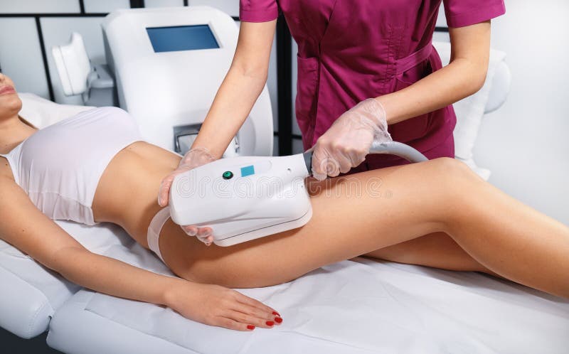 Young woman getting cryolipolyse treatment in cosmetic cabinet. Fat freezing technology on legs. Cool sculpting procedure stock photos Young woman getting cryolipolyse treatment in cosmetic cabinet. Fat freezing technology on legs. Cool sculpting procedure stock photos