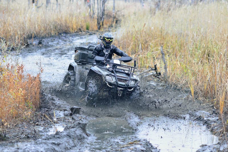 Cool view of active ATV and UTV driving in mud and water