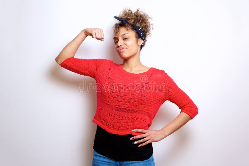 Portrait of cool young black woman flexing bicep muscle