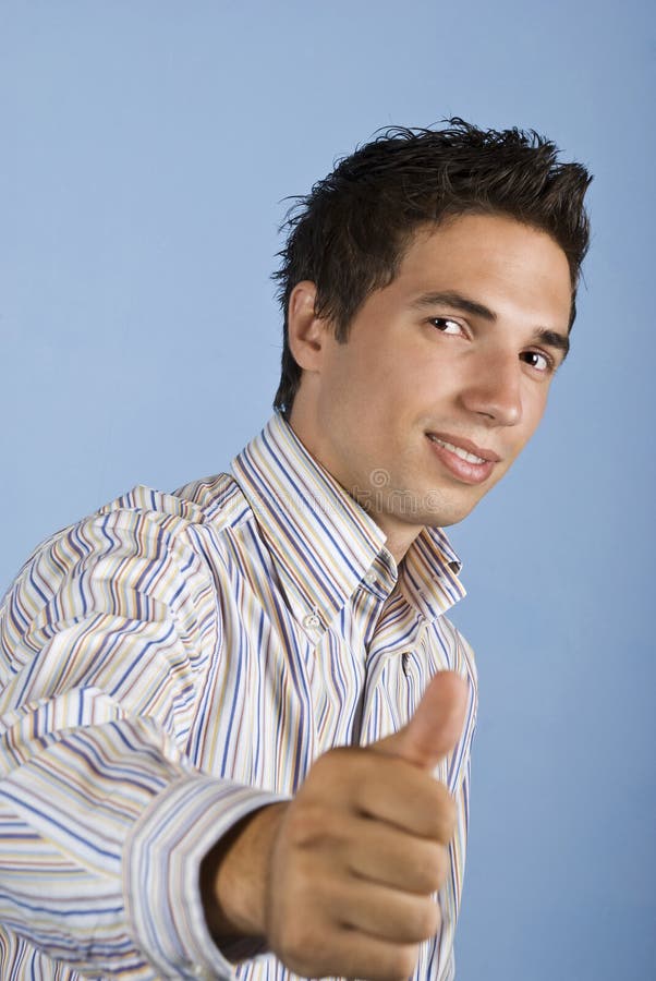 Cool young business man giving thumbs up
