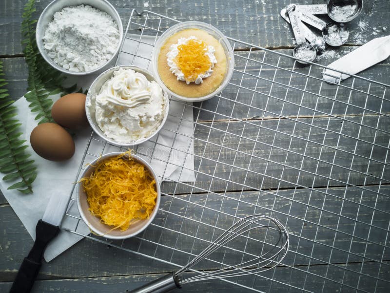 Cooling Rack with Delicious Cupcakes on Wooden Background, Top View