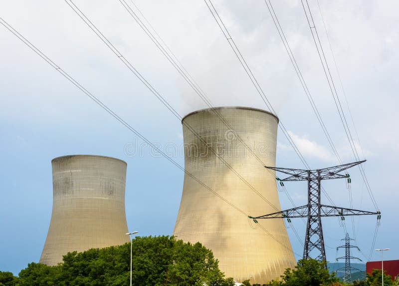 Cooling towers of a nuclear power plant and electricity pylons with high voltage power line