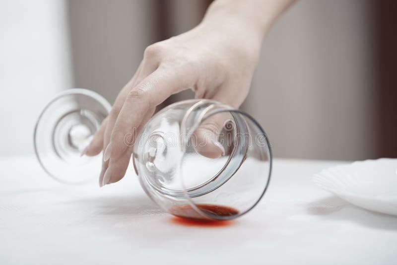 Human hand taking fallen wineglass. Human hand taking fallen wineglass