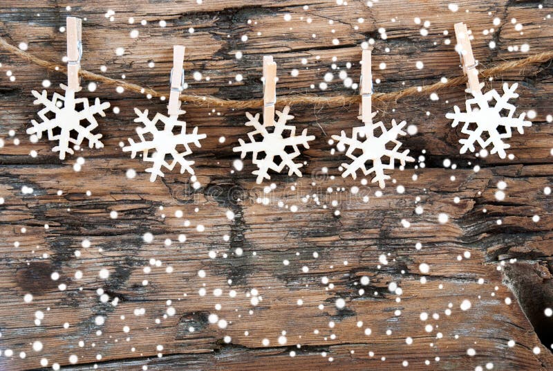 Wooden Snowflakes on a line with Snowflakes on Wood, Christmas or Winter Background. Wooden Snowflakes on a line with Snowflakes on Wood, Christmas or Winter Background