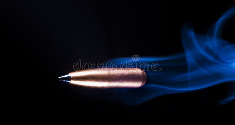 Bullet flying with smoke behind stock image