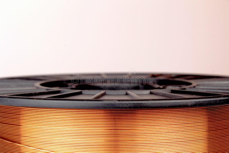 Copper Coated Steel Wire on a Plastic Spool. Welding Wire. Stock Photo