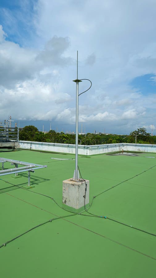 Copper grounding rod and lightning arrester installed at the highest point of a building stock photography